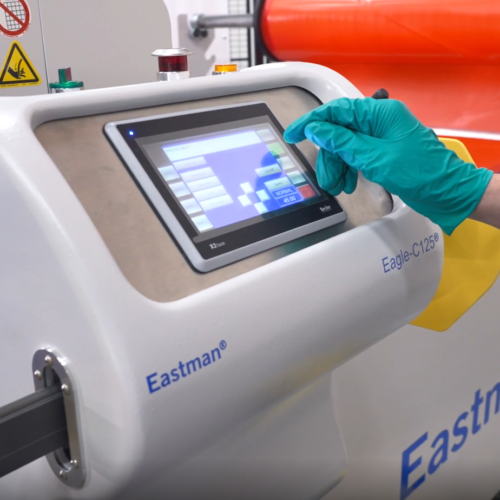 Gloved hand hovers over touch screen on Eastman Eagle C125