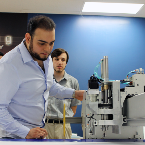Stanser CEO Jesus Trevino looks at Eastman machine
